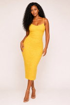 A woman modeling a bright yellow ribbed spaghetti-strap midi dress against a plain light background.